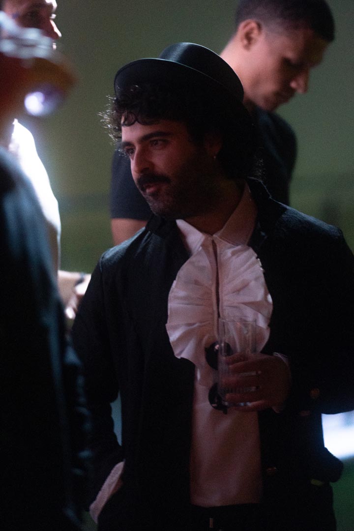 Ruffled shirt, top hat — late entrance.