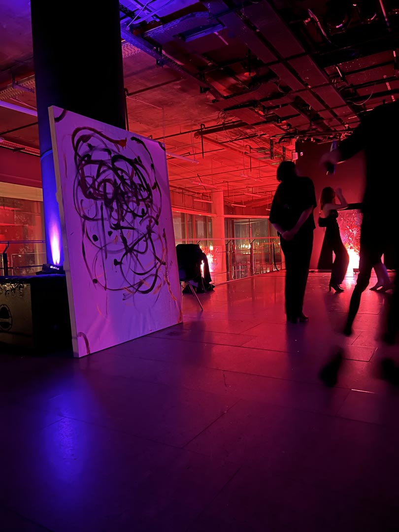 Live painting under crimson light.